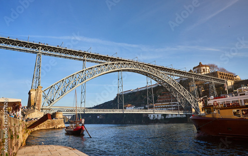 View of the historic city of Porto, Portugal with the Dom Luiz bridge. A metro train can be seen on the bridge
