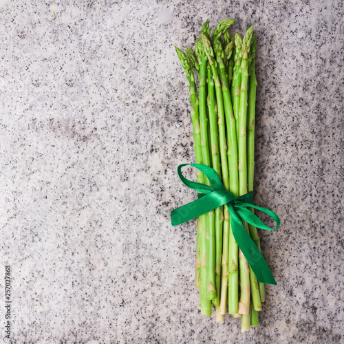 Fresh asparagus tied with green ribbon  top view