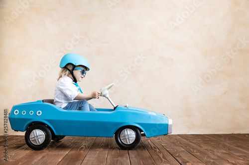 Funny kid driving toy car at home © Sunny studio