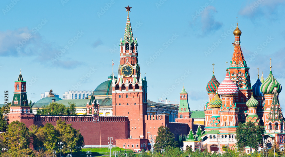 Spasskaya Tower of Moscow Kremlin and Cathedral of Vasily the Blessed (Saint Basil's Cathedral) in sunny day. Red Square. Moscow. Russia