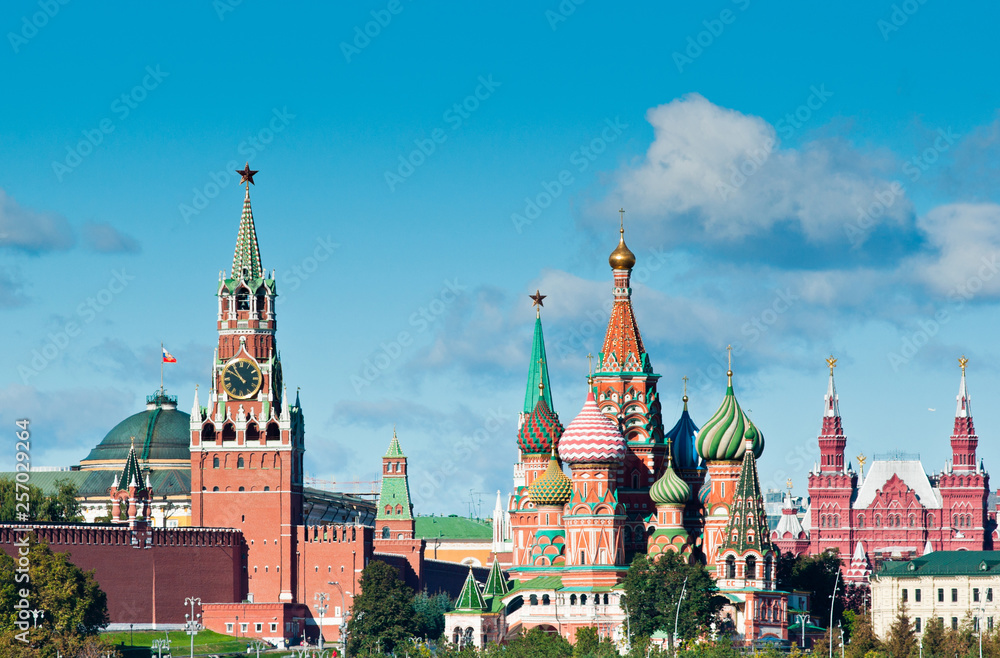 Spasskaya Tower of Moscow Kremlin and Cathedral of Vasily the Blessed (Saint Basil's Cathedral) in sunny day. Red Square. Moscow. Russia Spasskaya Tower of Moscow Kremlin and Cathedral of Vasily the Blessed (Saint Basil's Cathedral) in sunny day. Red Square. Moscow. Russia