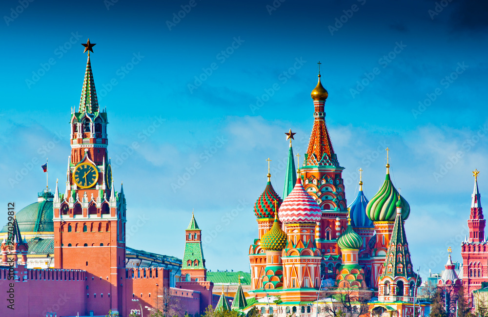 Moscow Kremlin view. Spasskaya Tower  and the Cathedral of Vasily the Blessed (Saint Basil's Cathedral) on Red Square. Sunny winter day. Moscow. Russia