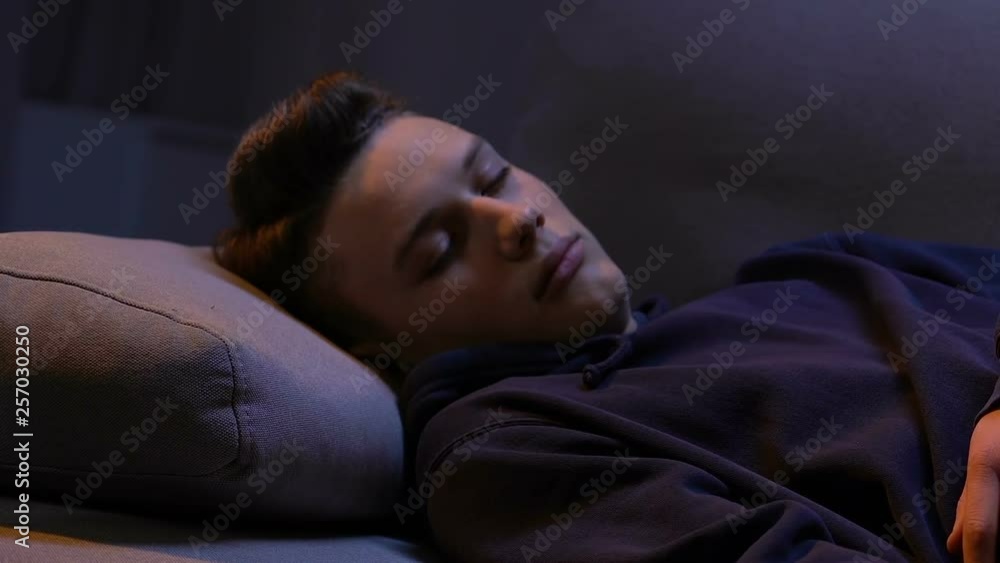 Tired young man falling on bed, exhausted after extra working hours, sleeping Tired young man falling on bed, exhausted after extra working hours, sleeping