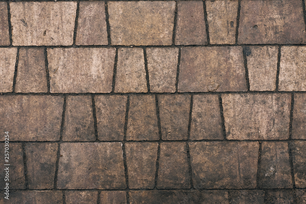 Naklejka premium dirty tiles in the street. Gray background