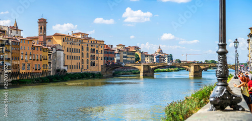 Panoramic view of medieval arched St Trinity bridge (Ponte Santa Trinita) over Arno river in Florence, Italy, Europe. 