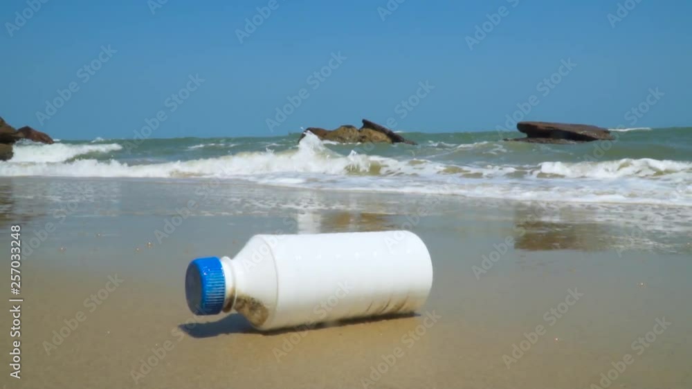 Plastic bottle on sea shore. Ocean Scenery Rubbish And Pollution Slow motion Plastic bottle on sea shore. Ocean Scenery Rubbish And Pollution Slow motion
