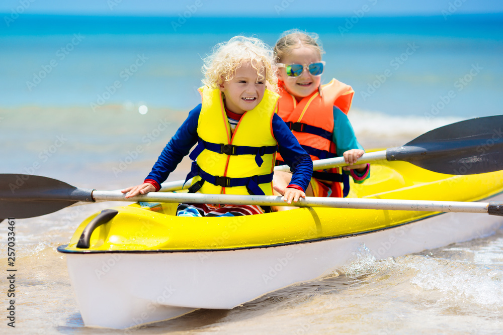 Obraz premium Kids kayaking in ocean. Children in kayak in tropical sea