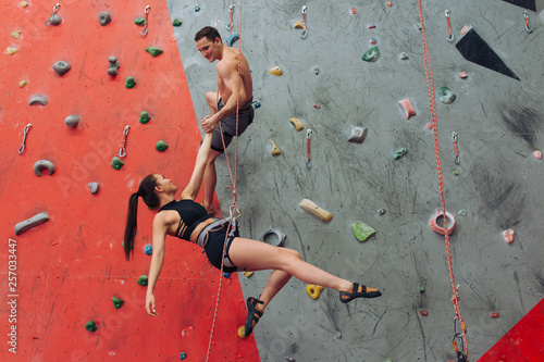 happy athletes performing dangreous movements while climbing. full length photo. lifestyle , happiness, success
