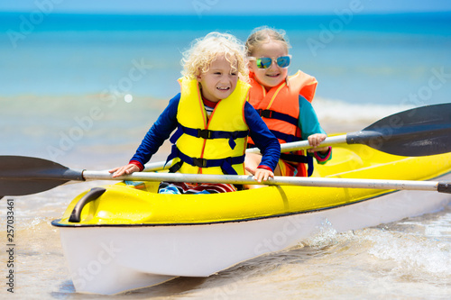 Kids kayaking in ocean. Children in kayak in tropical sea