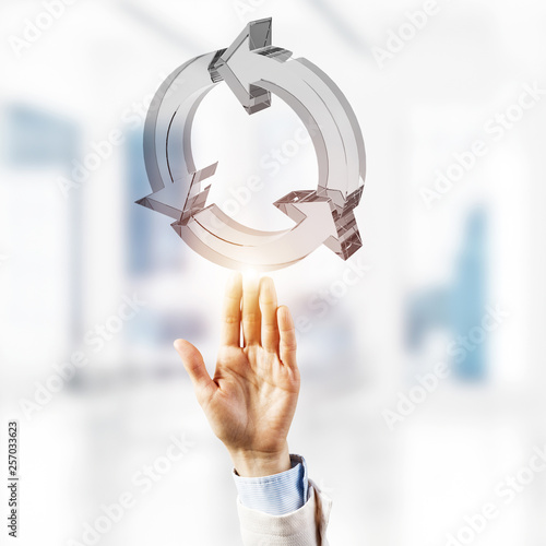Web refresh icon and male hands as symbol for internet use. Mixed media