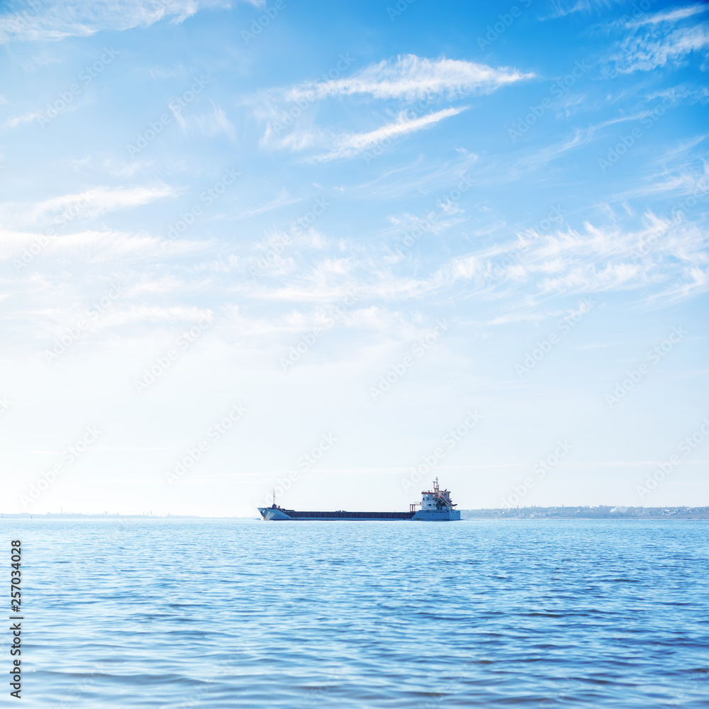 big ship on the river and blue sky with clouds above it