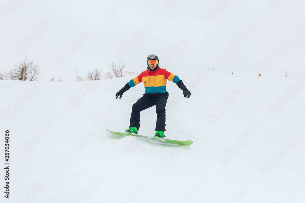 ambitious man is good at snowboarding, favourite hobby, pastime, full length photo.
