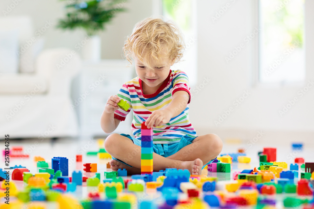 Child playing with toy blocks. Toys for kids. Child playing with toy blocks. Toys for kids.