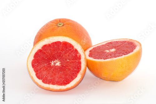 Slices of grapefruit macro closeup on white background