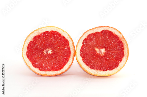 Slices of grapefruit macro closeup on white background