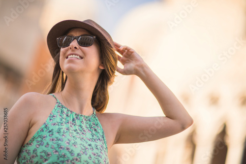 Beautiful tourist woman looking around and searching direction. Taken from low angle.