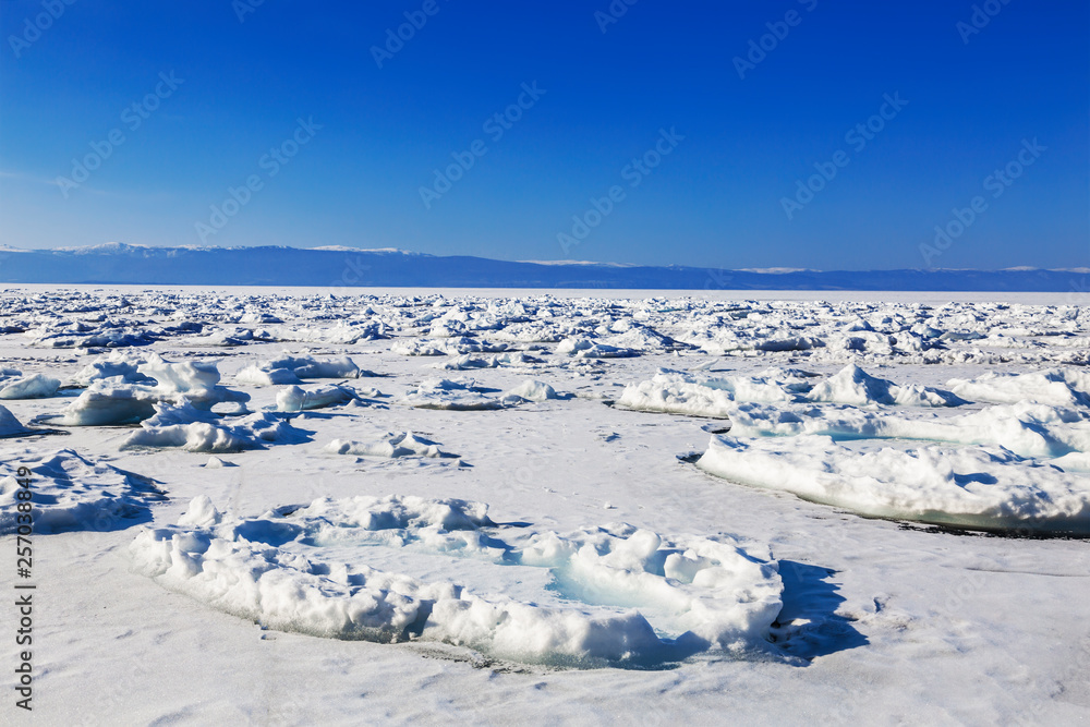 View of the frozen lake Baikal on a Sunny day. Irkutsk region, Russia