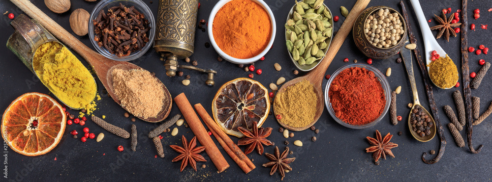 Spices and herbs. Colorful spices flat lay on wooden table - obrazy, fototapety, plakaty 