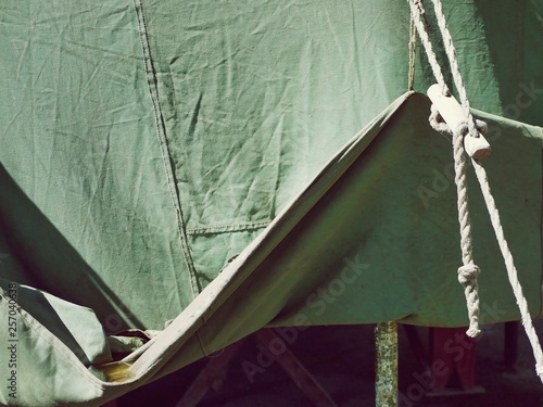  Raised edge of a green tent, tarpaulin texture, outdoor recreation concept