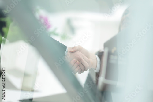 business background.blurred image of business partners shaking hands