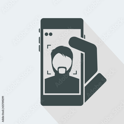 Smartphone take a photo to a bearded boy