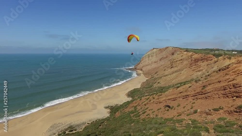 Aerial Near View of Paraglider Flying Over Beach 