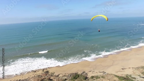 Aerial Paraglider Turning Over Beach 