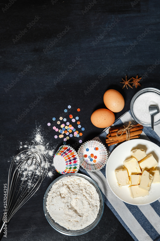 Bakeware baking, fresh ingredients and cookies on a black background. Flat lay bakery text image space