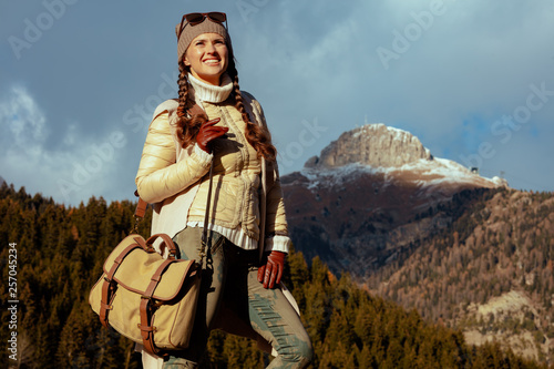 traveller woman against mountain landscape enjoying promenade
