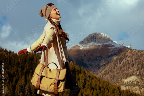 traveller woman against mountain scenery rejoicing