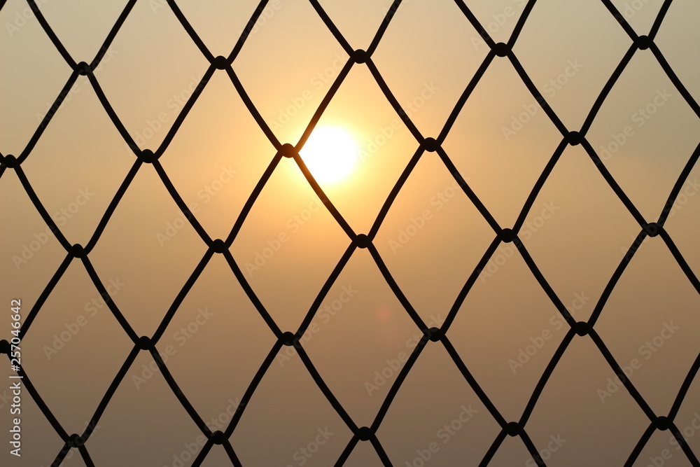 Fototapeta premium Steel mesh with sunsets