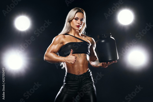 Athletic young woman bodybuilder on steroids have a cheat meal. Fitness and sport concept. Nutrition and bodybuilding. © Mike Orlov