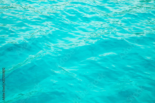 Blue clear water. Beautiful blue sea wave photograph close up. Beach vacation at sea or ocean. Background to insert images and text. Tourism  travel.