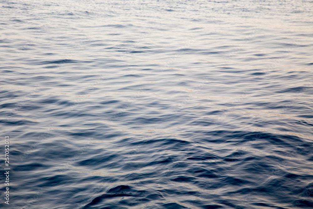 Blue clear water. Beautiful blue sea wave photograph close up. Beach vacation at sea or ocean. Background to insert images and text. Tourism, travel. Blue clear water. Beautiful blue sea wave photograph close up. Beach vacation at sea or ocean. Background to insert images and text. Tourism, travel.