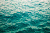 Blue clear water. Beautiful blue sea wave photograph close up. Beach vacation at sea or ocean. Background to insert images and text. Tourism, travel.