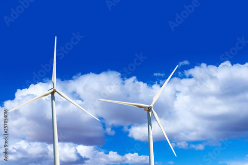 Wind mill generator turbines with cloudy sky