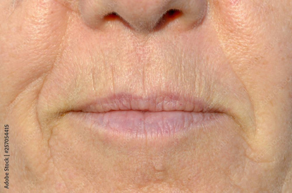 Close up on the mouth of a middle-aged woman Close up on the mouth of a middle-aged woman
