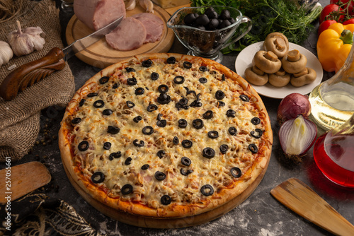 Pizza with ham  mushrooms  black olives and onions