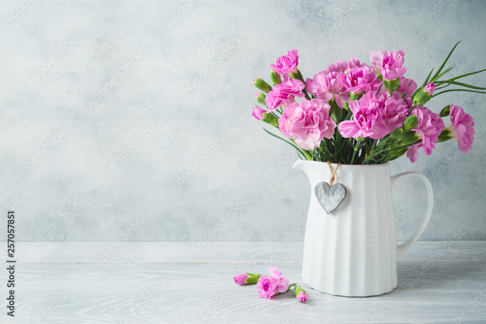 Mother's day background with flowers and heart shape on wooden table Mother's day background with flowers and heart shape on wooden table