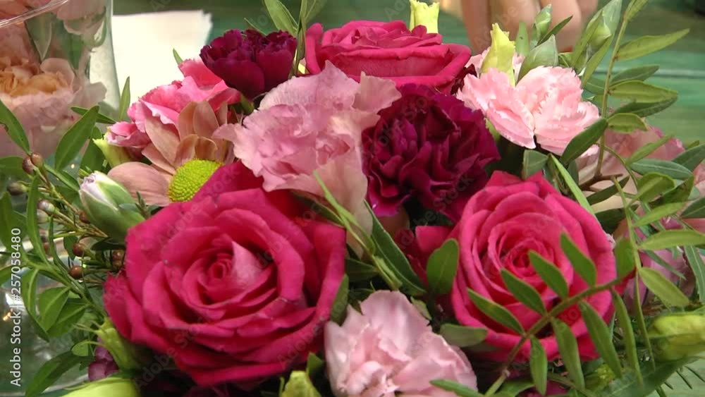 Video filming with hands without stabilization. Bouquet of colorful roses and other flowers at the entry to flower shop at farmers' market. Everyday flowers counter with variety of fresh cut flowers. Video filming with hands without stabilization. Bouquet of colorful roses and other flowers at the entry to flower shop at farmers' market. Everyday flowers counter with variety of fresh cut flowers.