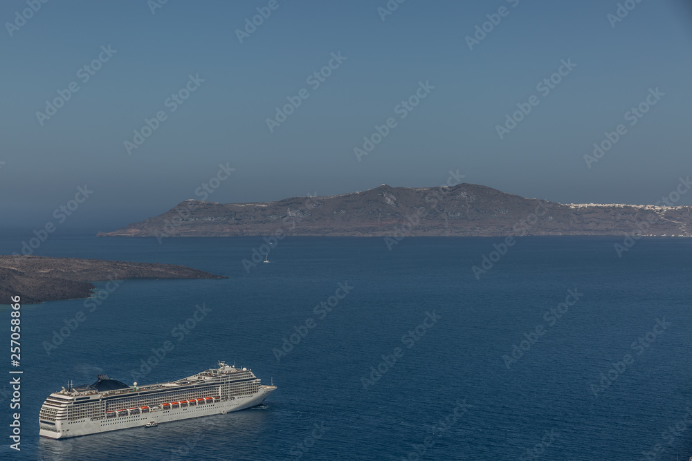 Large cruise ship cruising the seas near some islands