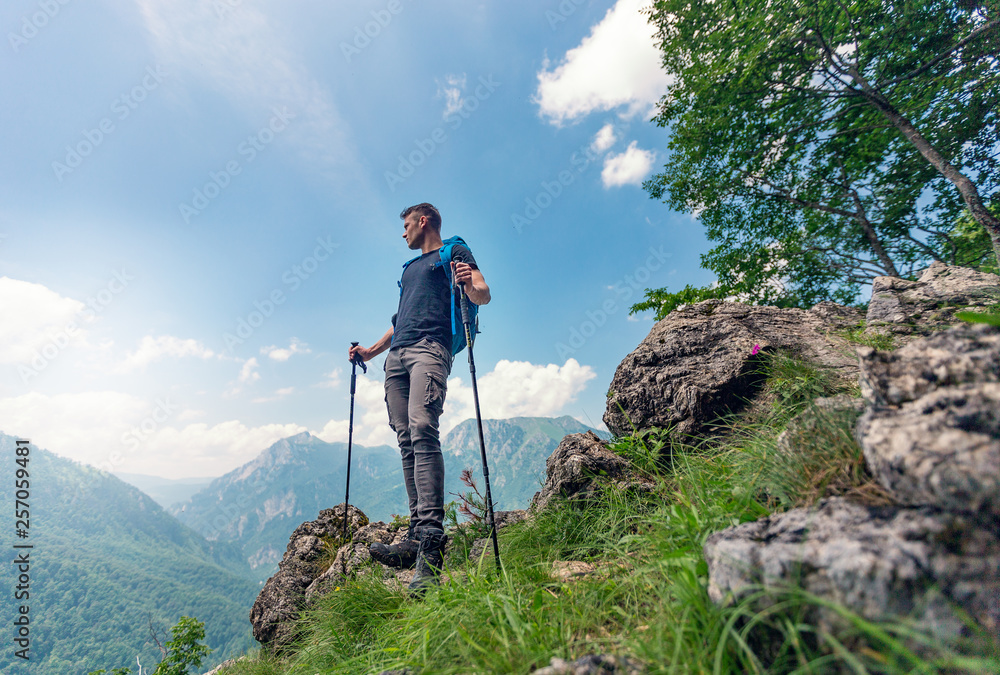 Male hiker with backpack enjoying nature view