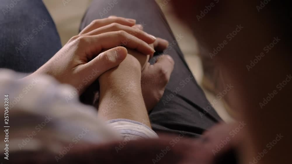 Couple holding hands for support during family therapy session.close up on hands Couple holding hands for support during family therapy session.close up on hands