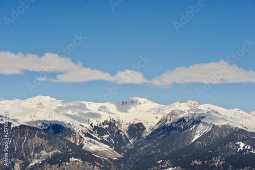 View of a snowy mountain with clouds 