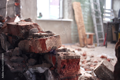 Repair and construction of the house. Broken brick wall indoors closeup.