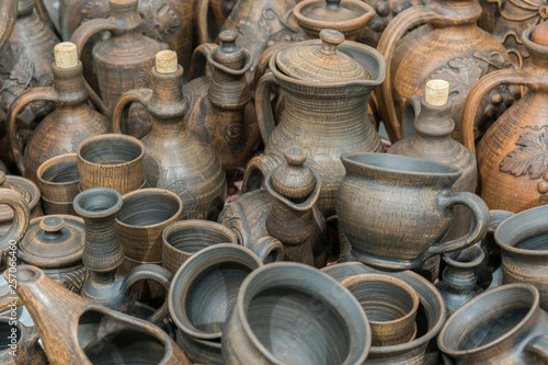 Clay dishes. Ceramic national Ukrainian dishes made in the Poltava region in the village of Opishnya and demonstrated at the in Velyki Sorochyntsi Fair. Burnt black ceramics. Burned clay jars