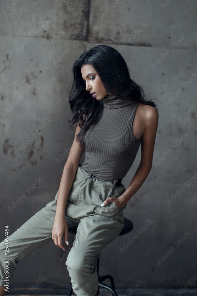 Beautiful young brunette posing in casual clothes. Beautiful young brunette posing in casual clothes.