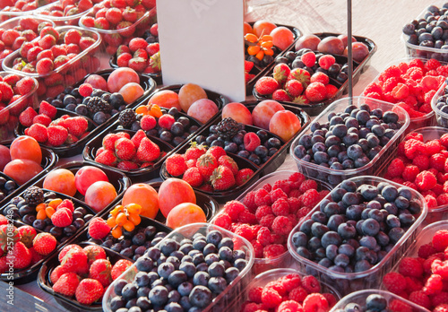 Berries in the plastic boxes sell on the market