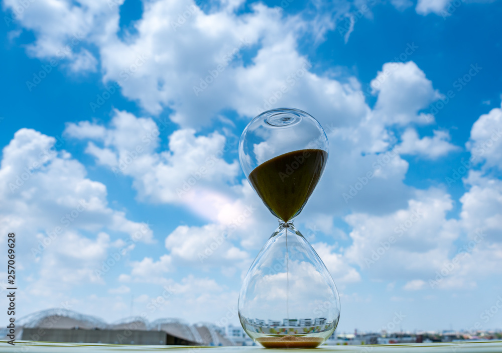 Sand clock with sky and cloud business concept Sand clock with sky and cloud business concept