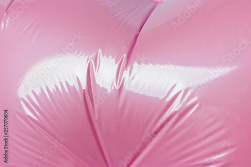 Detail of the folds of a helium pink balloon from foil